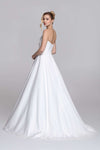Strapless wedding dress with draped top and slit on the skirt.