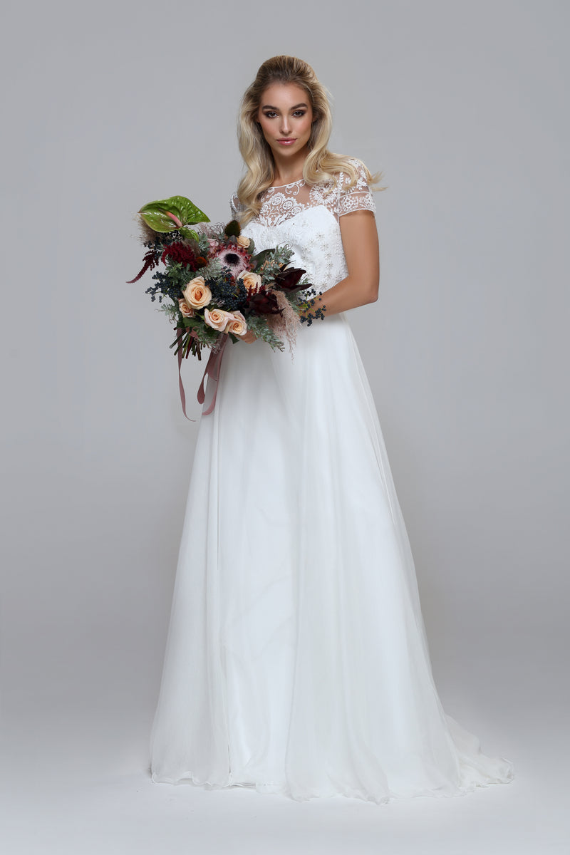 Wedding dress with beaded top and silk chiffon skirt. Boat neckline with V-back.